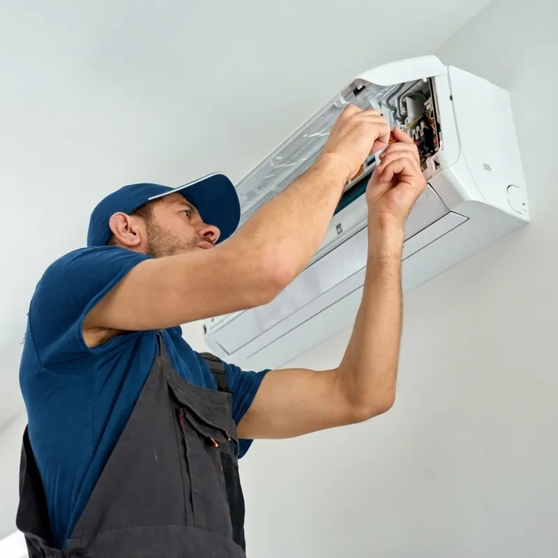 AC Repair Newark technician repairing the internals of a wall-mounted air conditioner